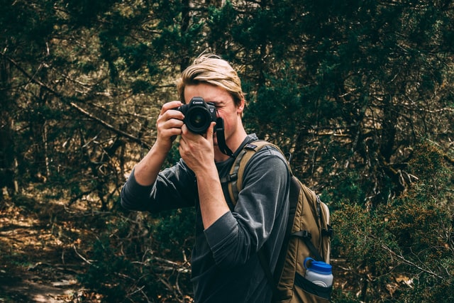 Man Taking A Photo While Hiking
